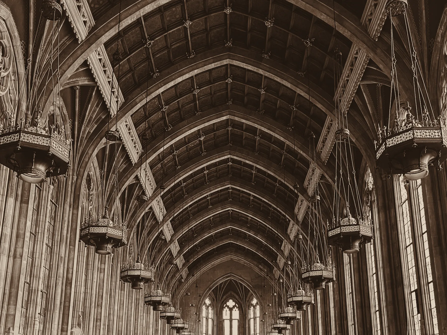 The vaulted ceiling and lamps of a historic reading hall