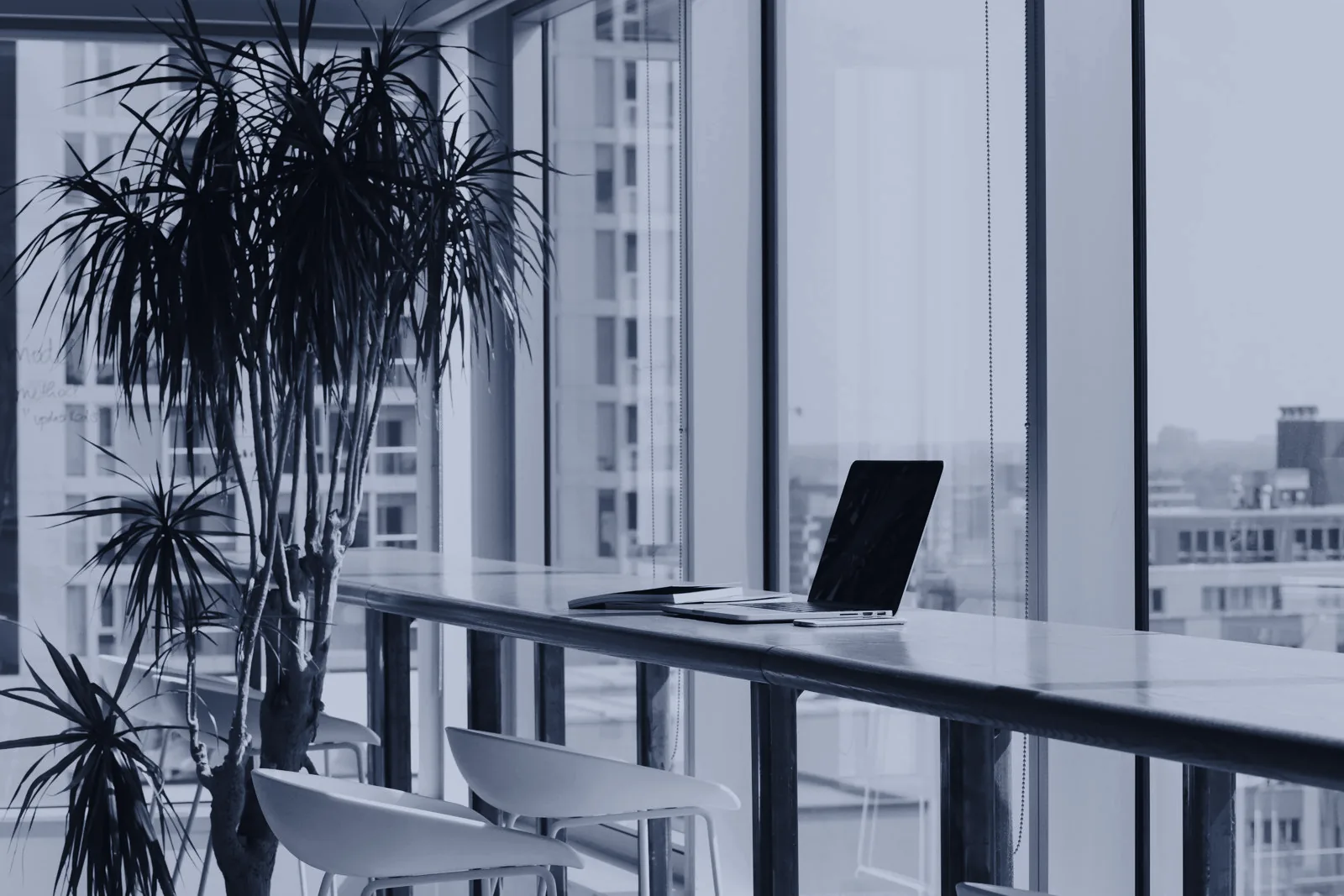 A quiet workspace with a laptop by a window